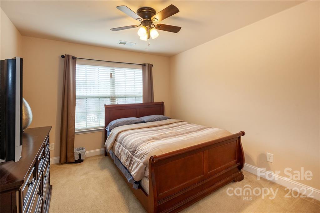 688 Winding Branch Road Rock Hill, SC 29732 - Photo 31 of 38 a bedroom with a bed chandelier and a window