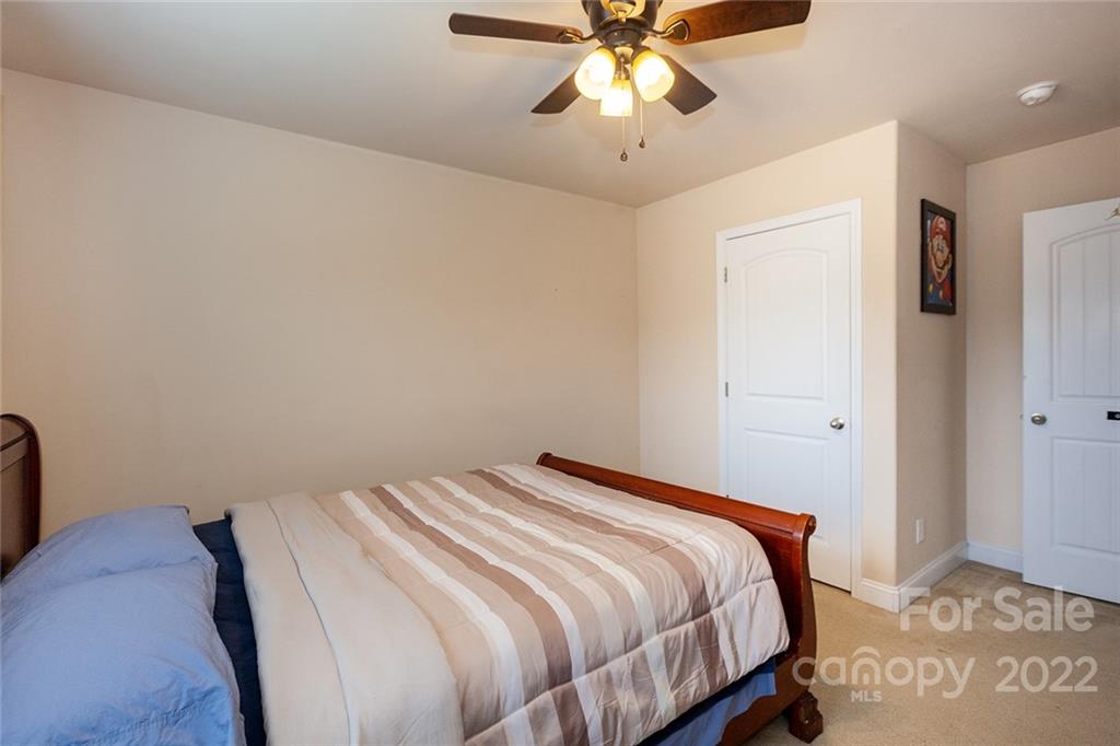 688 Winding Branch Road Rock Hill, SC 29732 - Photo 32 of 38 a bedroom with a bed and a chandelier