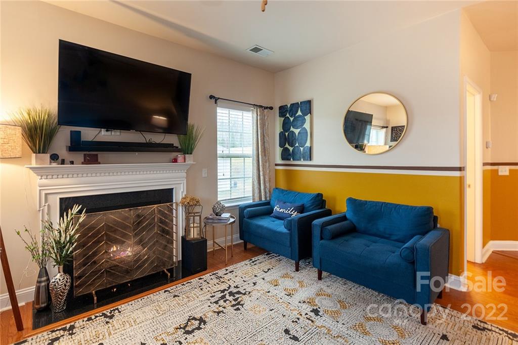 688 Winding Branch Road Rock Hill, SC 29732 - Photo 5 of 38 a living room with furniture a flat screen tv and a fireplace