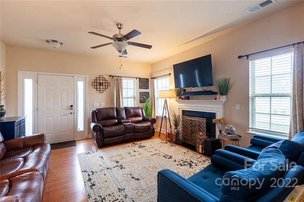 688 Winding Branch Road Rock Hill, SC 29732 - Photo 6 of 38 a living room with furniture a flat screen tv and a fireplace