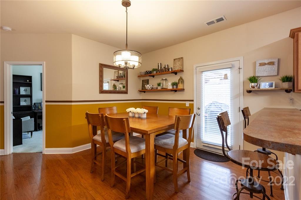 688 Winding Branch Road Rock Hill, SC 29732 - Photo 9 of 38 a view of a dining room with furniture wooden floor and chandelier