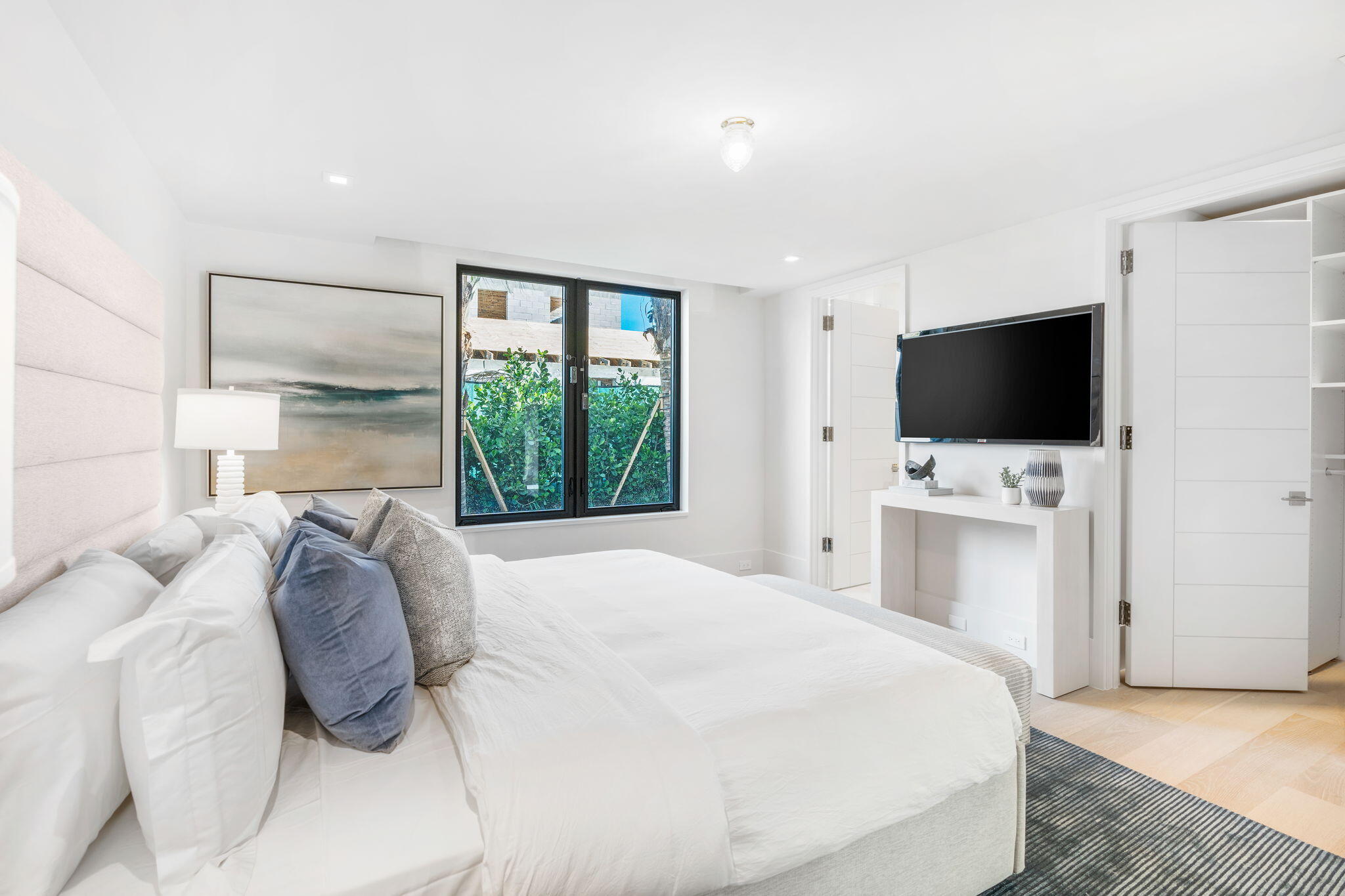 2291 Ibis Isle Road East Palm Beach, FL 33480 - Photo 18 of 32 a bedroom with a bed tv and a window