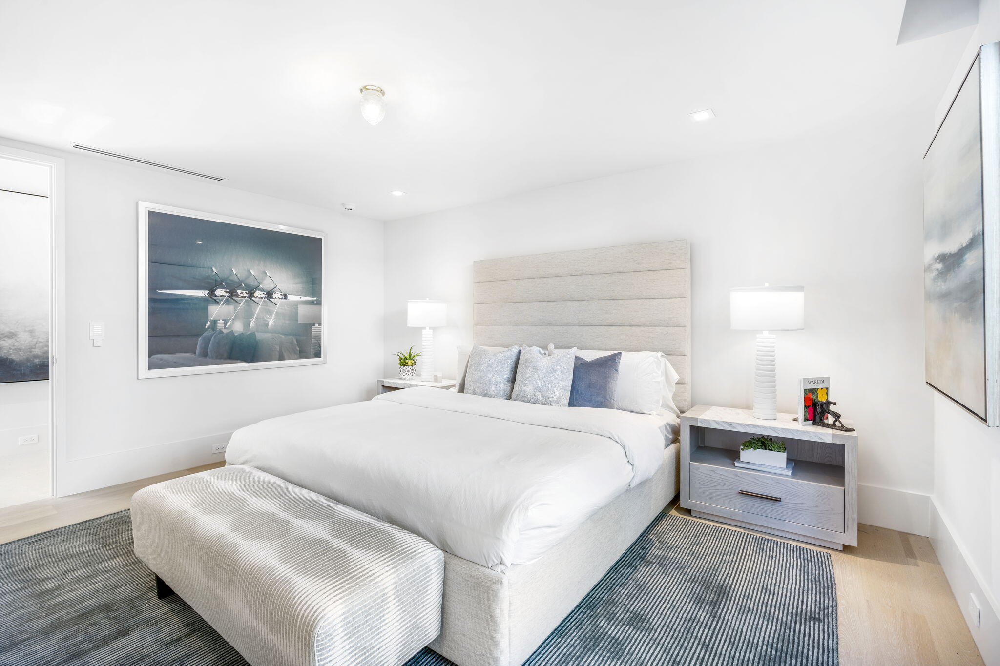 2291 Ibis Isle Road East Palm Beach, FL 33480 - Photo 20 of 32 a bedroom with a bed and a chandelier