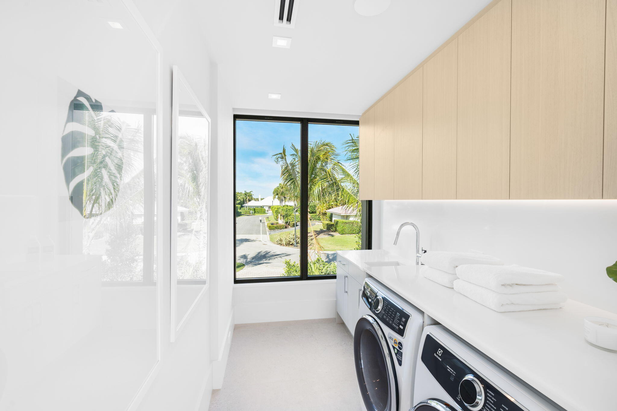 2291 Ibis Isle Road East Palm Beach, FL 33480 - Photo 23 of 32 a utility room with a sink a washer and dryer