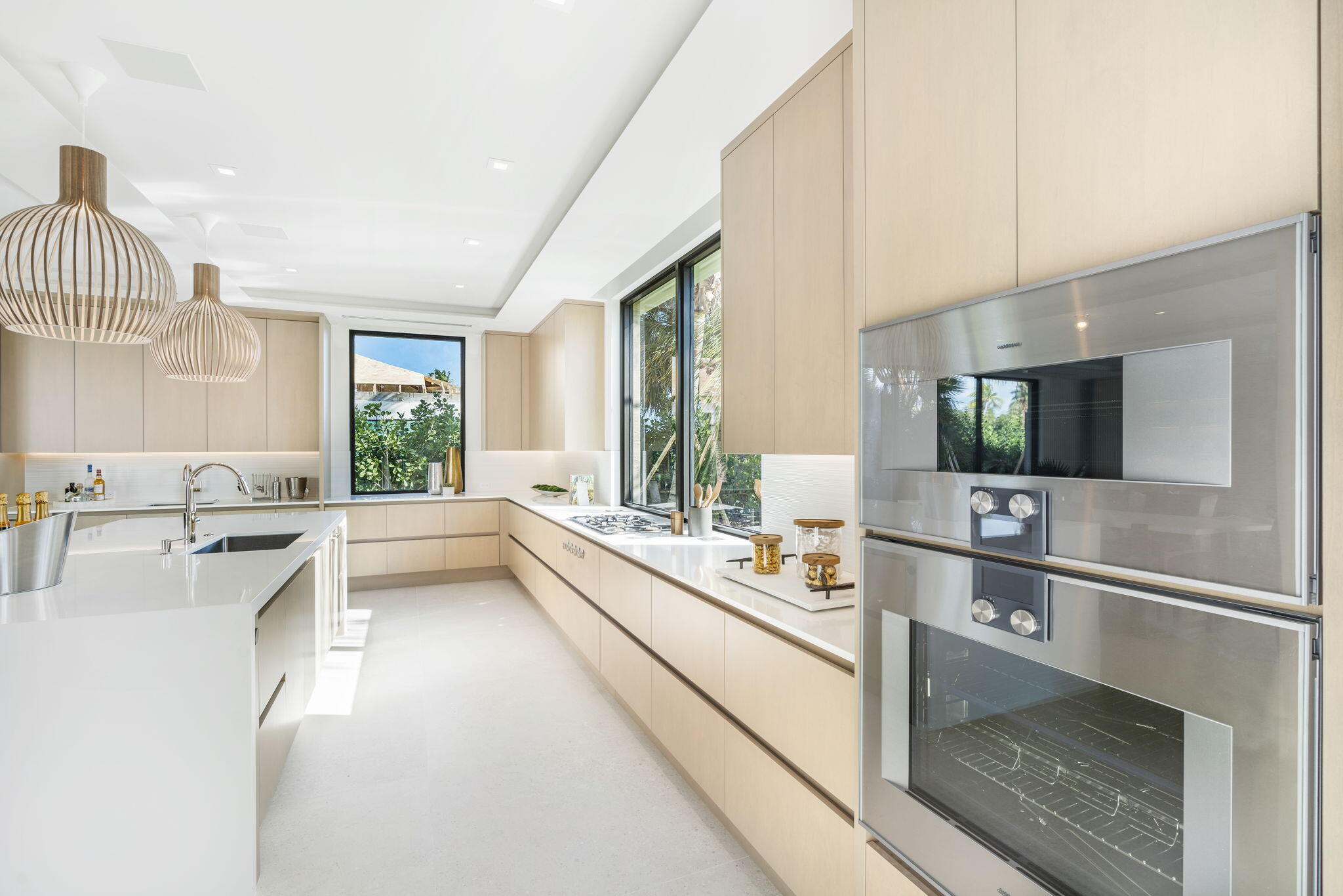 2291 Ibis Isle Road East Palm Beach, FL 33480 - Photo 8 of 32 a large white kitchen with a window and sink