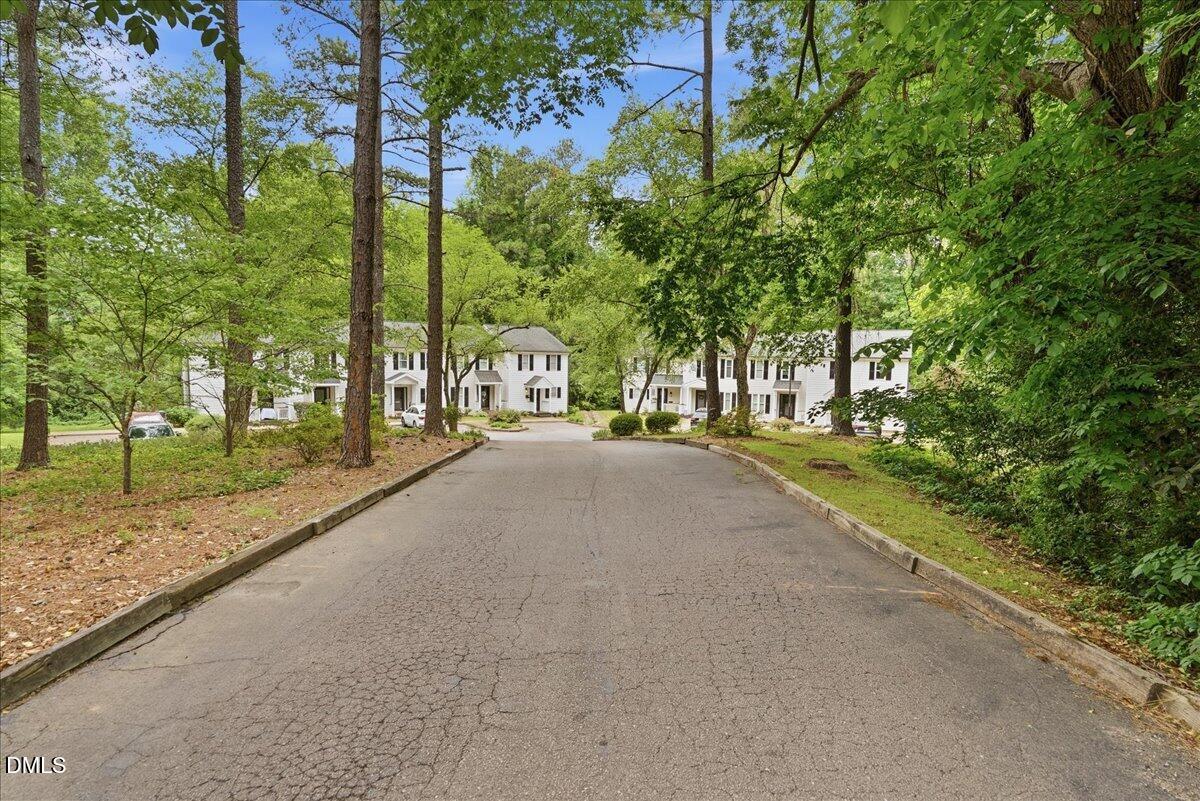 2834 Wayland Drive Raleigh, NC 27608 - Photo 26 of 26 a view of a street with a building and trees in the background