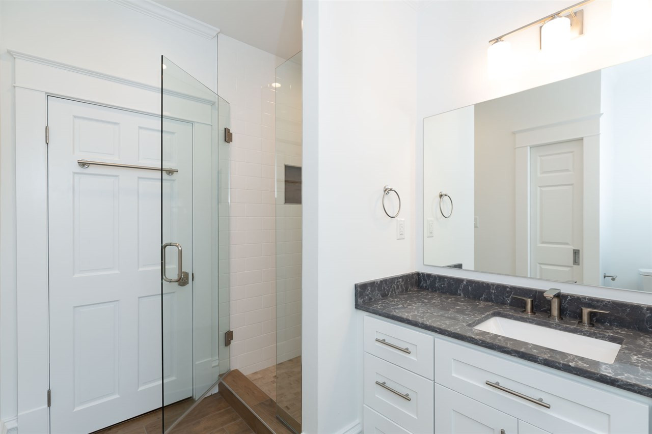 1607 Scales Street Raleigh, NC 27608 - Photo 17 of 27 a bathroom with a granite countertop sink two mirror and shower