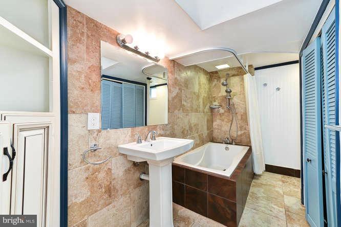 5918 Atteentee Road Springfield, VA 22150 - Photo 20 of 25 a bathroom with a sink a mirror and a shower