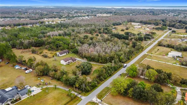 an aerial view of a residential houses with outdoor space