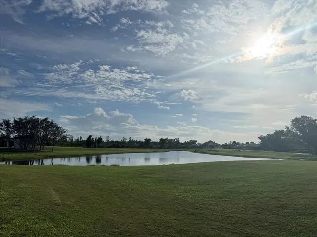 a view of a lake with houses in the background