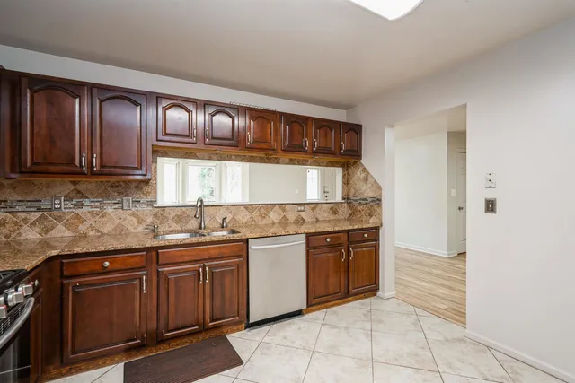 a kitchen with stainless steel appliances granite countertop a sink and cabinets