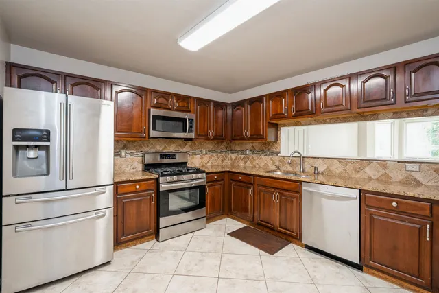 a kitchen with granite countertop stainless steel appliances and cabinets