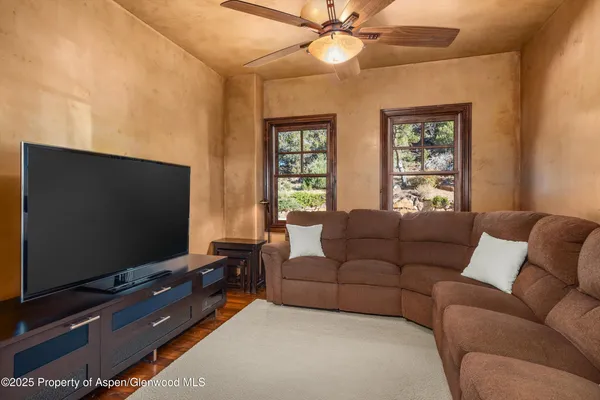a living room with furniture and a flat screen tv