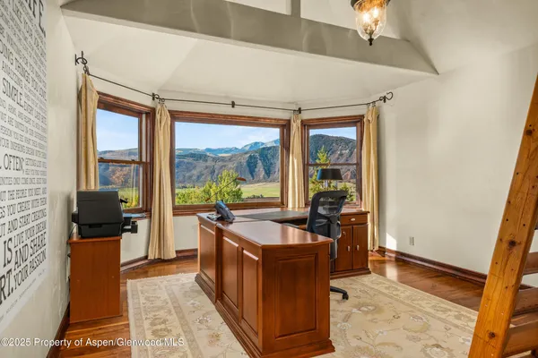 a living room with furniture and a floor to ceiling window