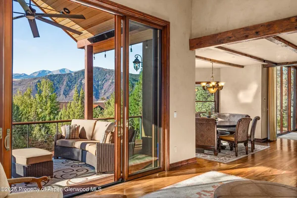 a living room with furniture and a floor to ceiling window