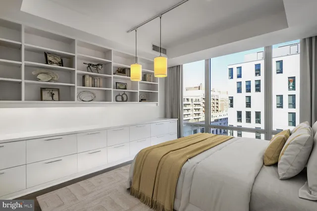 a bedroom with a bed and a large window