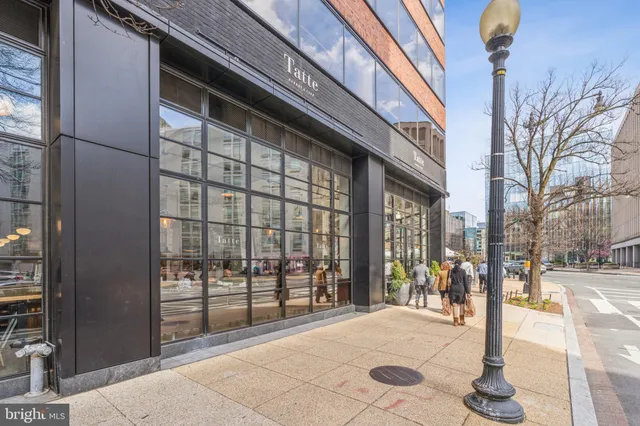 a living room with furniture wooden floor and a window