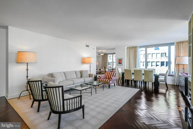 a living room with furniture a fireplace and a large window