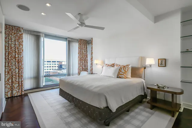 a dining room with furniture and a floor to ceiling window