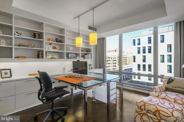 a bedroom with two beds and a window