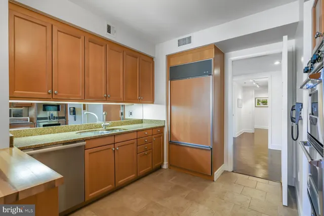 a kitchen with stainless steel appliances granite countertop a refrigerator and a sink