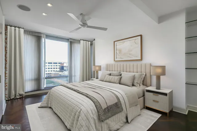 a bedroom with a large bed and a large window