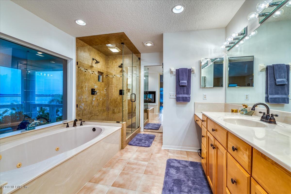 16125 Shellcracker Road Jacksonville, FL 32226 - Photo 15 of 31 a spacious bathroom with a tub sink shower and mirror