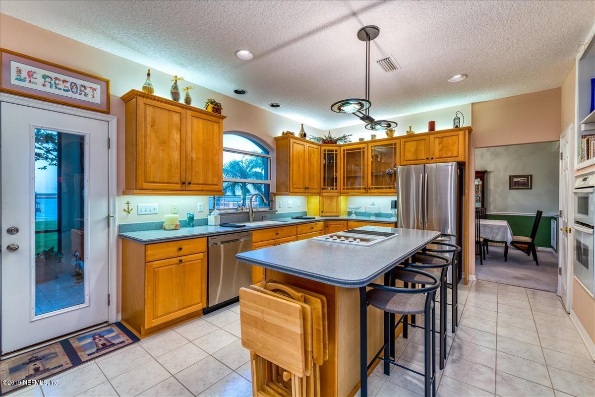 16125 Shellcracker Road Jacksonville, FL 32226 - Photo 9 of 31 a room with stainless steel appliances kitchen island granite countertop a table chairs and a refrigerator
