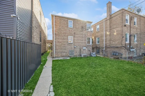 a view of a brick wall in front of a building