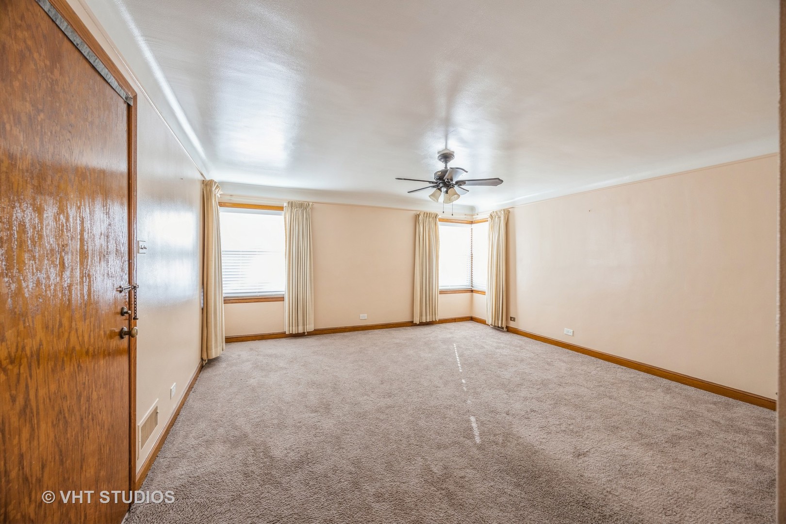 2452 West Marquette Road Chicago, IL 60629 - Photo 3 of 11 an empty room with chandelier fan and windows