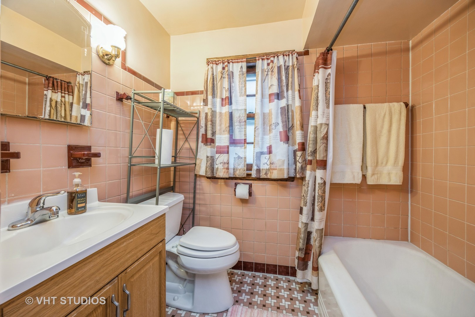 2452 West Marquette Road Chicago, IL 60629 - Photo 7 of 11 a bathroom with a sink a toilet and shower