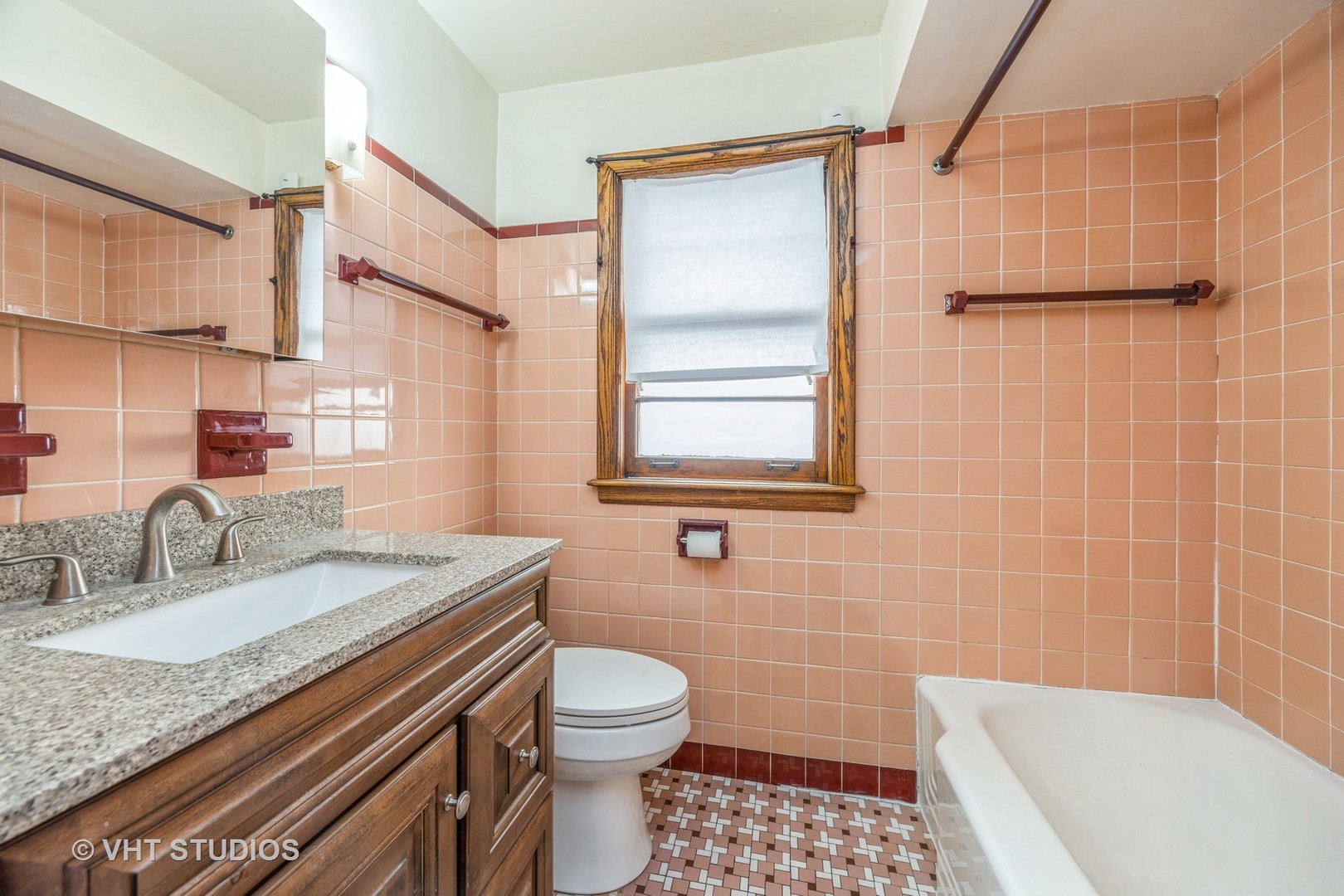 2452 West Marquette Road Chicago, IL 60629 - Photo 9 of 11 a bathroom with a granite countertop sink toilet a mirror and shower