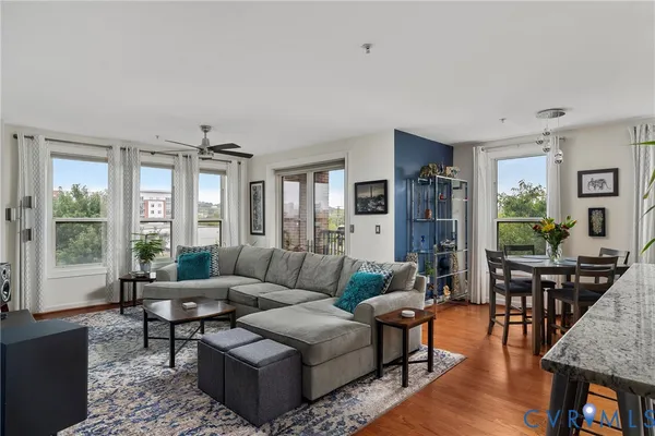 a living room with furniture a rug and a flat screen tv