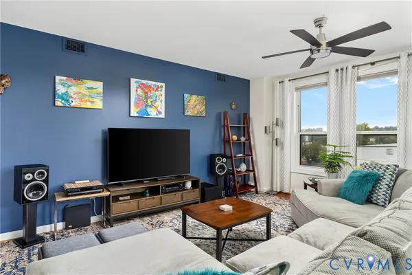 a kitchen with granite countertop a refrigerator a sink a stove and cabinets