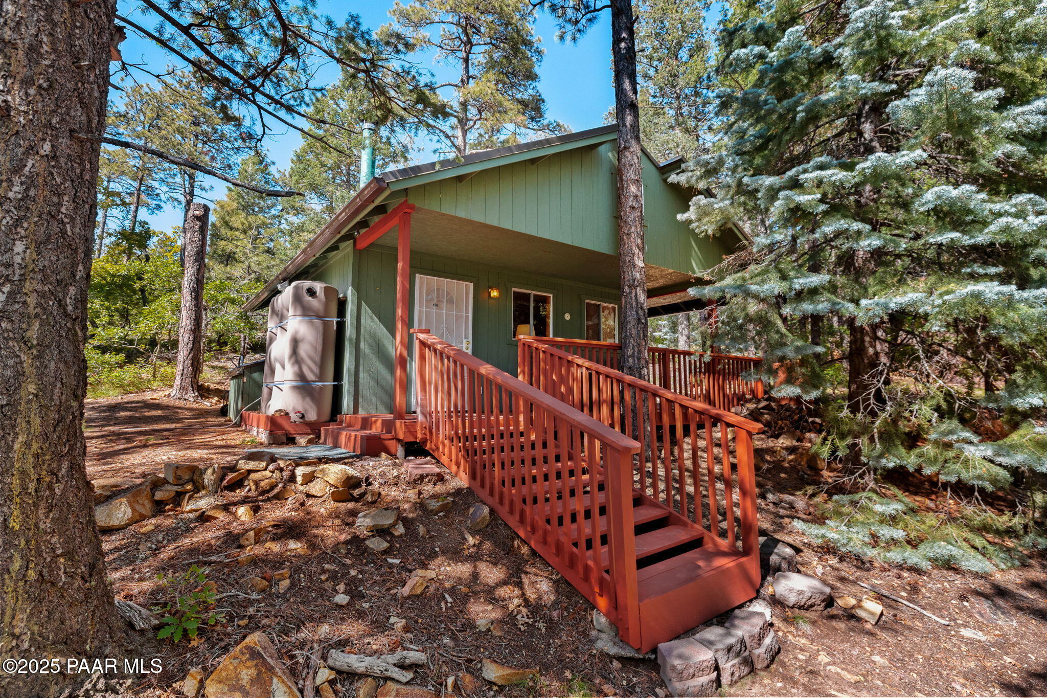 a view of a house with a small yard and wooden fence