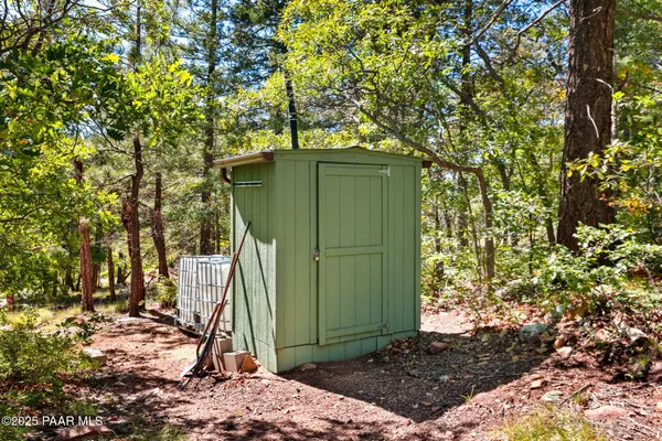 a green field with trees in the background