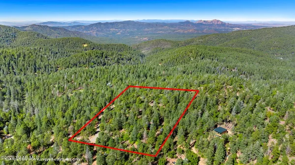 a view of a lush green hillside and a building