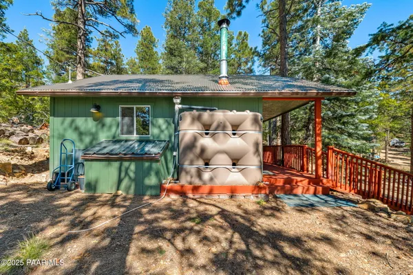 a backyard of a house with barbeque oven table and chairs