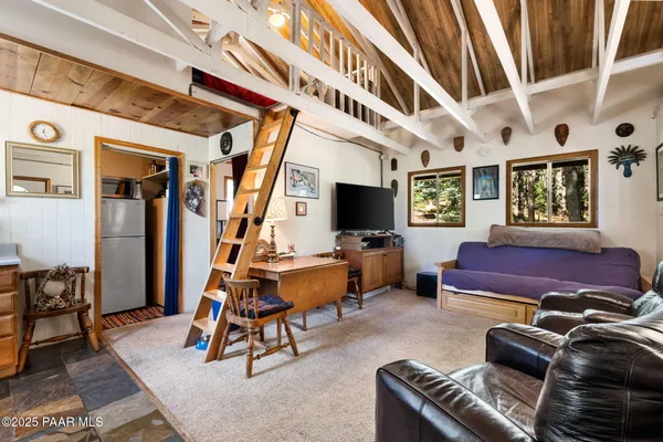 a living room with furniture gym equipment and a flat screen tv