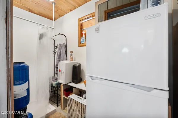 a bathroom with a shower and a mirror