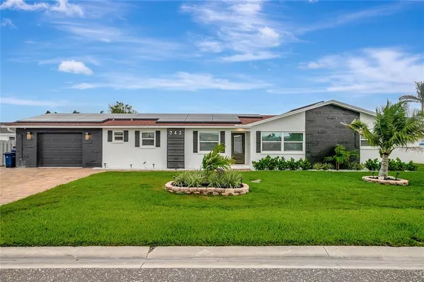 a front view of a house with a garden
