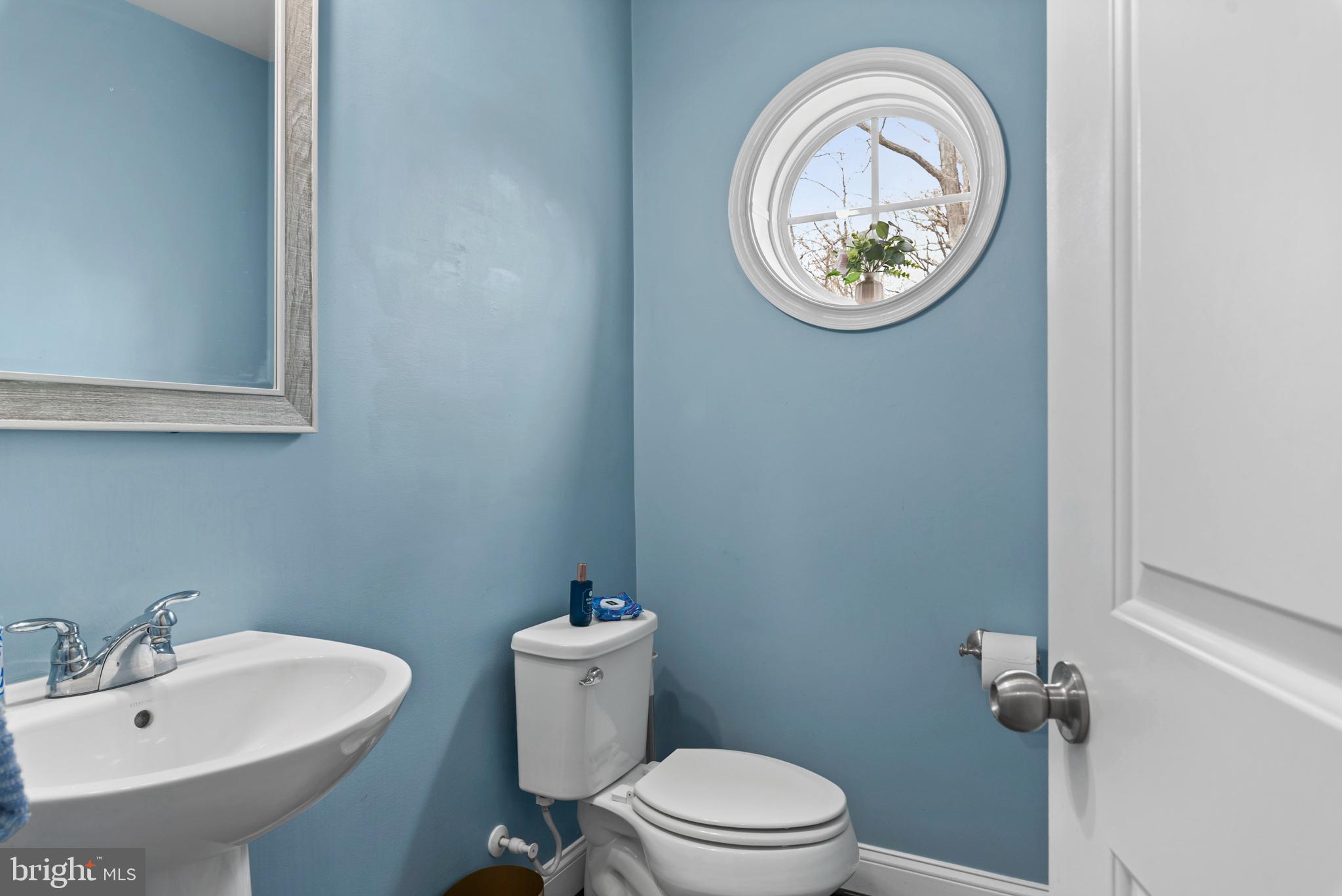 1614 Belle Drive Annapolis, MD 21401 - Photo 17 of 36 a bathroom with a sink a toilet and a mirror