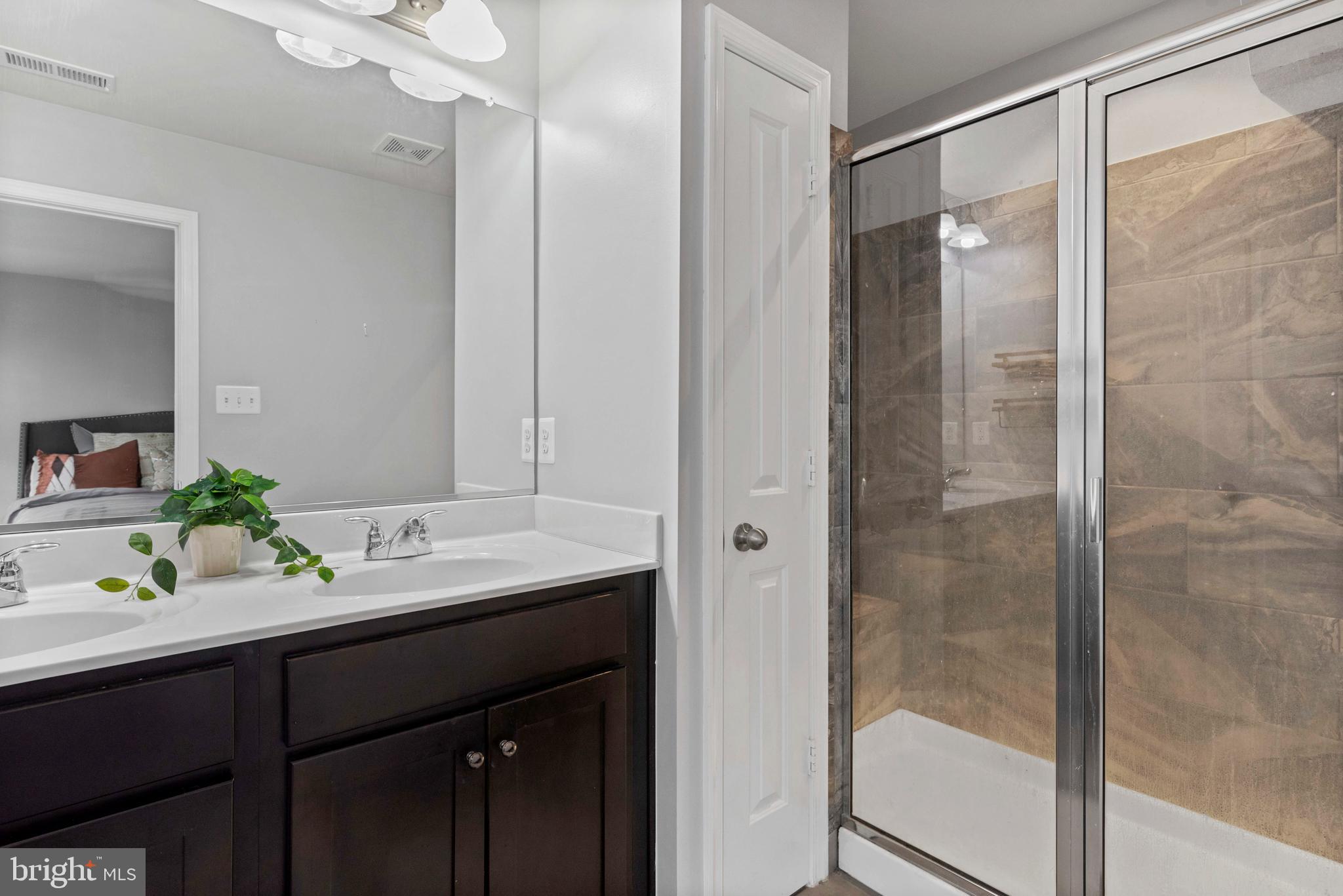 1614 Belle Drive Annapolis, MD 21401 - Photo 23 of 36 a bathroom with a sink and a mirror