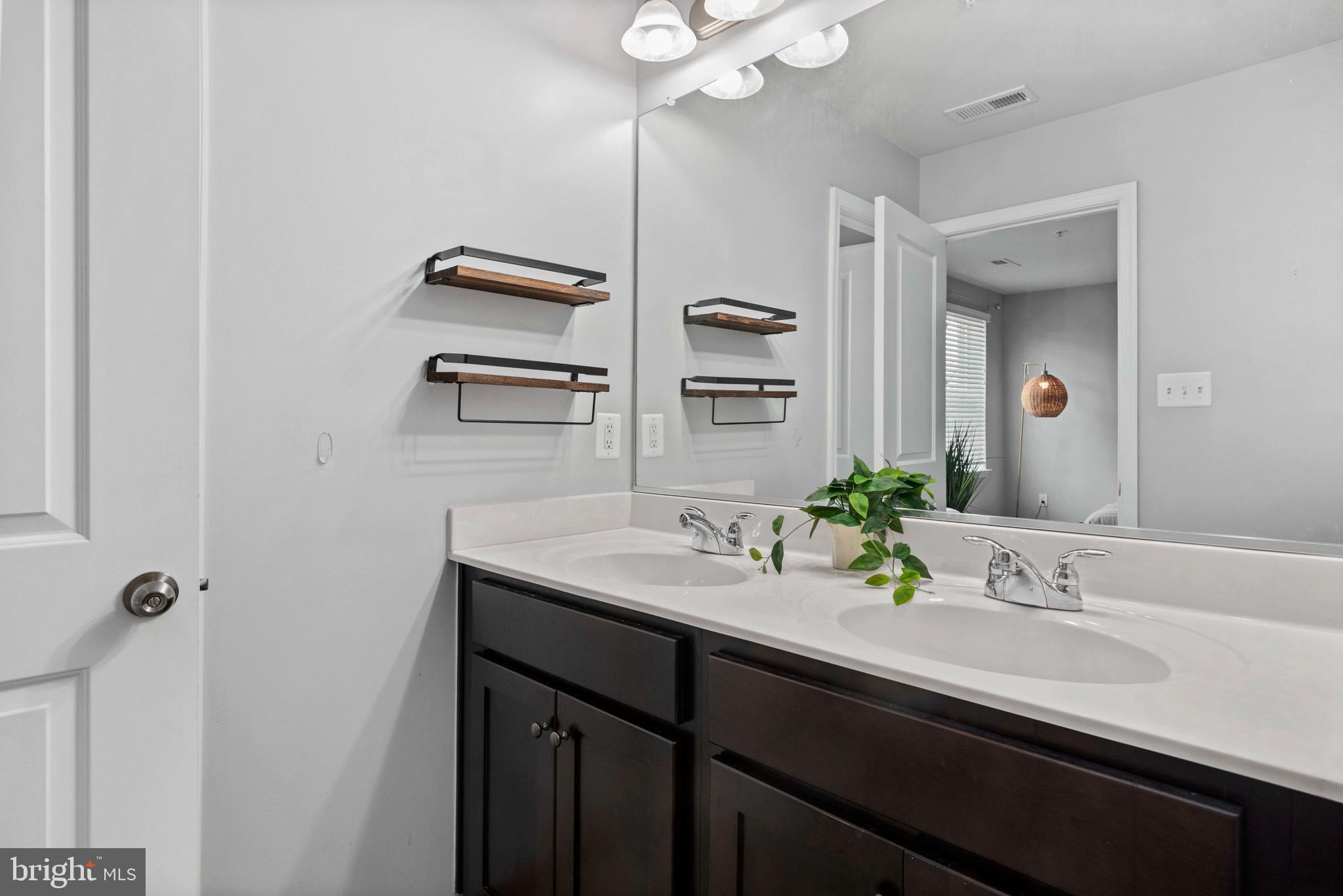 1614 Belle Drive Annapolis, MD 21401 - Photo 24 of 36 a bathroom with a sink double vanity granite tub shower and a mirror