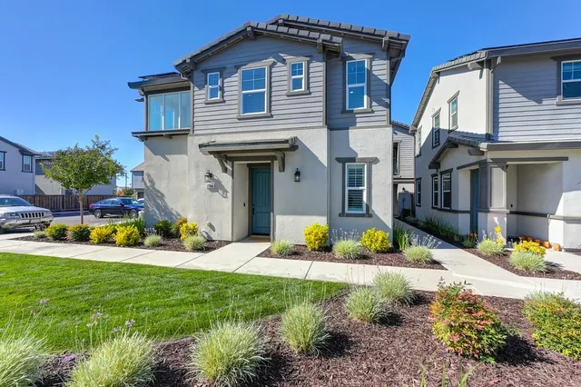 a front view of a house with a yard