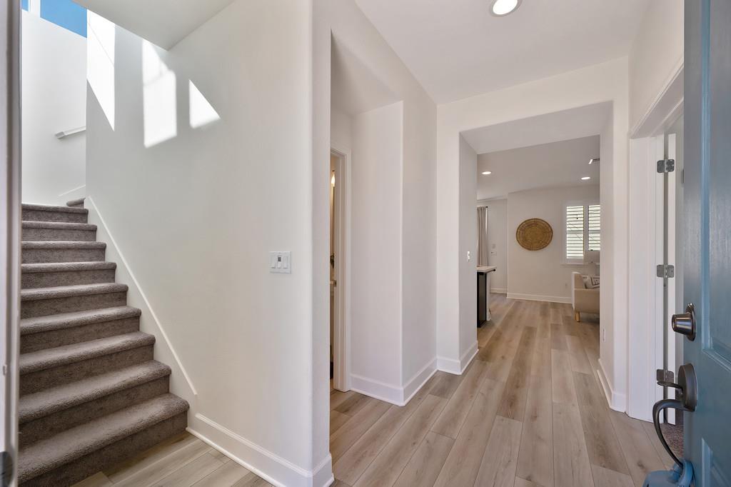 17500 Beachwood Road Lathrop, CA 95330 - Photo 11 of 78 a view of a hallway with wooden floor and staircase