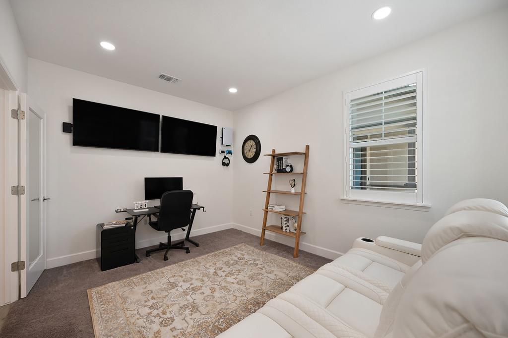 17500 Beachwood Road Lathrop, CA 95330 - Photo 17 of 78 a living room with furniture a flat screen tv and a window