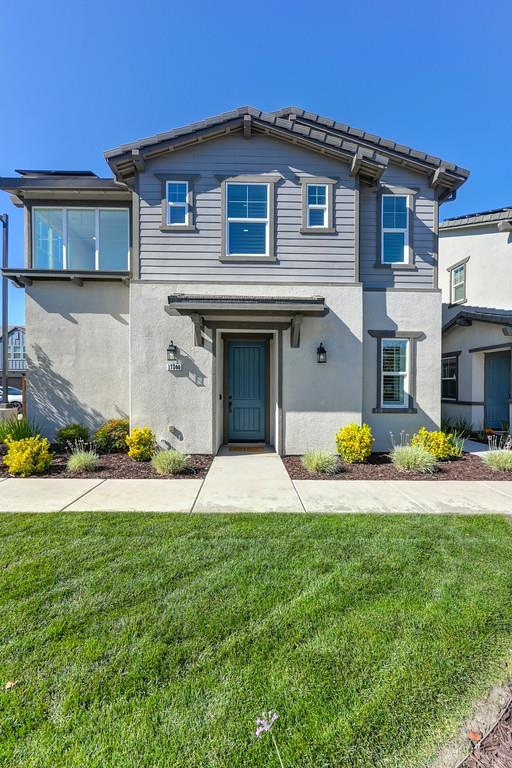 17500 Beachwood Road Lathrop, CA 95330 - Photo 2 of 78 a front view of a house with a yard and garage