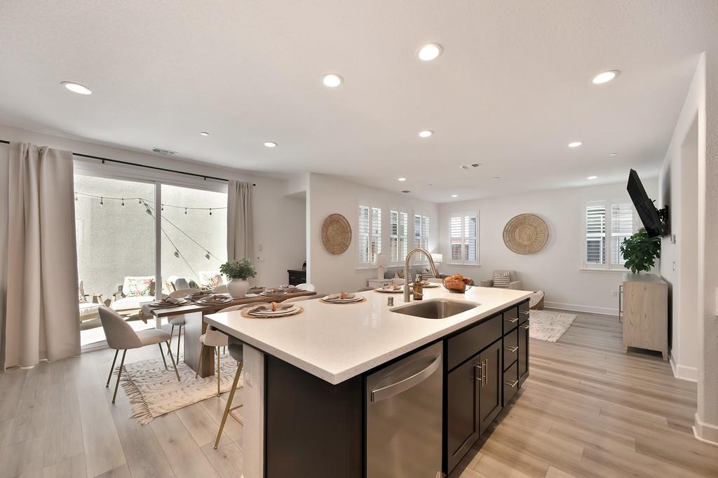 17500 Beachwood Road Lathrop, CA 95330 - Photo 23 of 78 a room with stainless steel appliances kitchen island granite countertop a sink and a large island with wooden floor