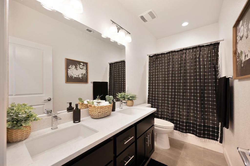 17500 Beachwood Road Lathrop, CA 95330 - Photo 39 of 78 a bathroom with a sink a toilet and shower